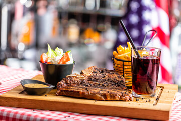 Beef steak dish with salad and french fries in american restaurant