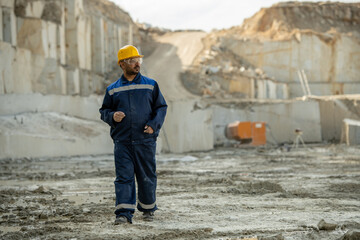 Contemporary builder in uniform moving down construction site