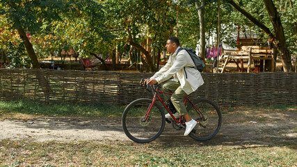 Fototapeta na wymiar Happy young african american man riding bike