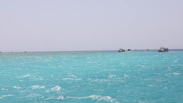 Summer sea view from coast with white yaht and mountains in background, Egypt