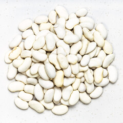 top view of pile of white beans close up on gray