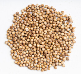 pile of dried coriander seeds close up on gray