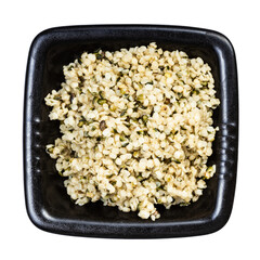 cores of hemp seeds in black bowl isolated