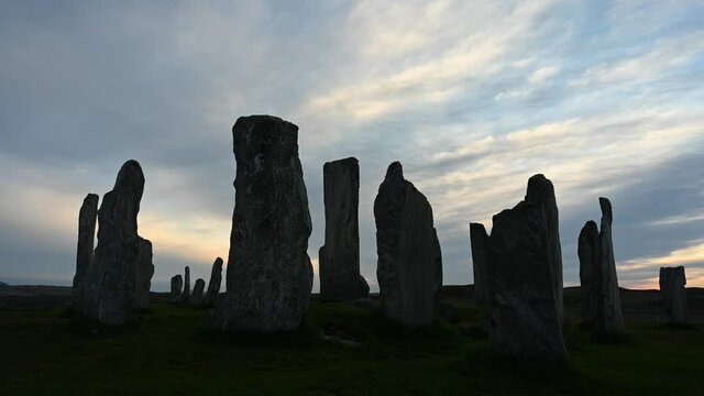 Time lapse of sky movement at sunset over Callanish stones, Isle of Lewis, Outer Hebrides. Stones are silhouetted against sky. No people.