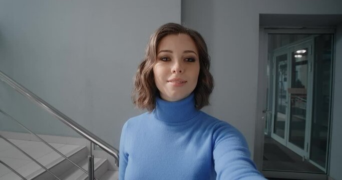Young woman uses an interactive scoreboard in the office's lobby, woman inserts the pincode on the cash machine, usage of the ATM at public place, 4k Prores HQ