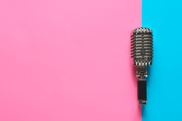 Retro microphone on color background