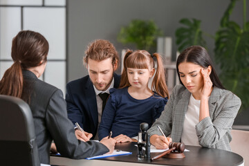 Young couple and their daughter visiting divorce lawyer in office