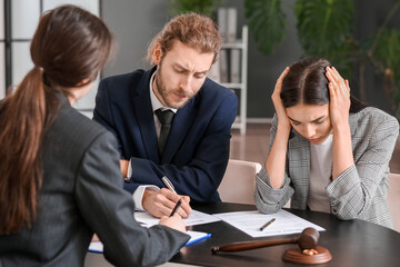 Young couple visiting divorce lawyer in office