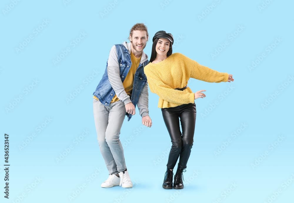 Poster happy young couple dancing on color background