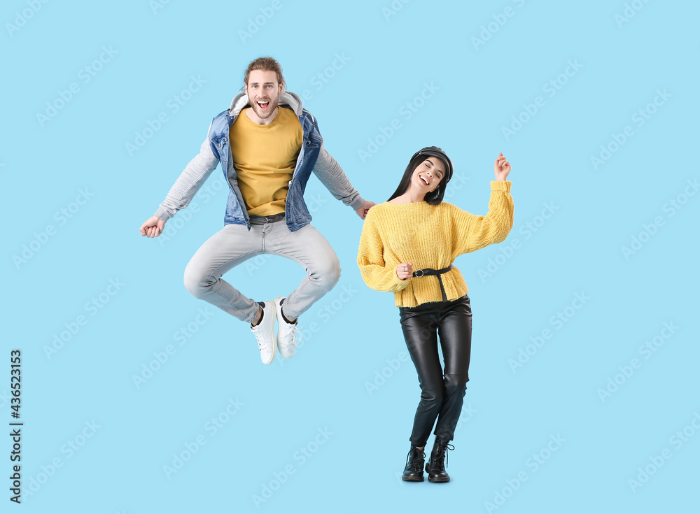 Sticker Happy young couple dancing on color background