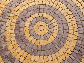 Background mosaic texture. The paving slabs are laid in the form of yellow and purple circles.