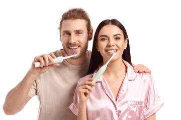 Young couple brushing teeth on white background