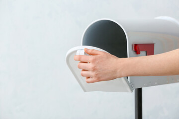 Woman with mail box on light background