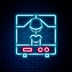 Glowing neon line X-ray machine icon isolated on brick wall background. Colorful outline concept. Vector