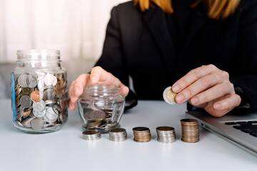 Male hand putting coins with money stack step growing growth and dollar bag. saving money, Concept finance business investment.