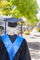 Muslim school graduate in cap and gown.