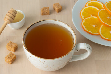 Green tea is poured into a cup.