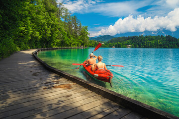 Active couple canoeing and enjoying the view, lake Bled, Slovenia