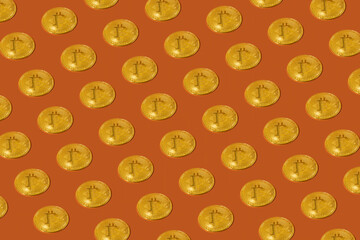 Abstract sample Gold bitcoin is placed on an orange background.