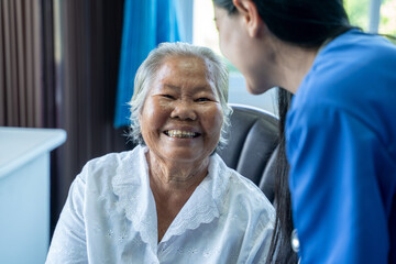 Obraz premium Happy elderly woman,Nurse giving psychological help and talking with elderly woman in a nursing home.