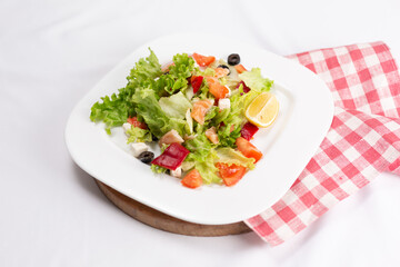 seafood salad with vegetables on white plate