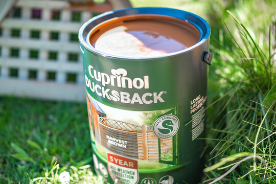 Norwich, Norfolk, UK – May 29 2021. Close Up Of A Can Of Cuprinol Ducks Back Wood Stain And Application Brush With Selective And Close Focus And Shallow Depth Of Field.