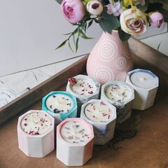 Beautiful soy candle decorated with dried flowers.
