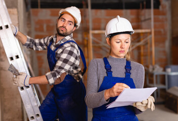 Female foreman checking the work of the builders in house. High quality photo