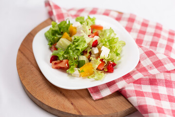 Greek salad with feta cheese on white plate