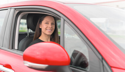 Beautiful young woman driving a car. Attractive brunette in the car.