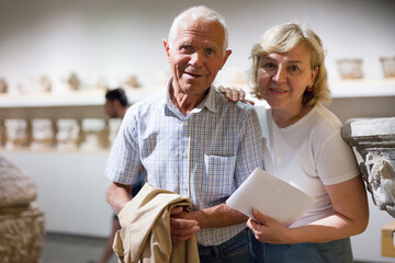 Portrait of elderly man and woman visiting museum of arts