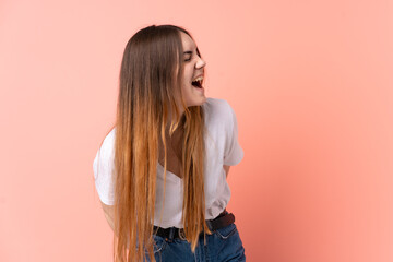 Young caucasian woman isolated on pink background laughing in lateral position