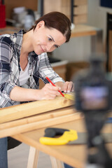 young female recording video for her carpentry blog