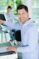 happy man using a copy machine