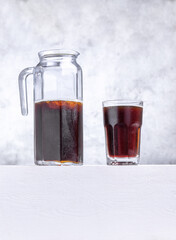 glass and jug of homemade bread kvass