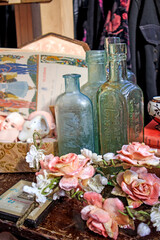 Spitalfields Antique Market. Porcelain figurines, vases, earthenware cup, plates, photo frames, bone beads, dog figures for sale at the flea market.