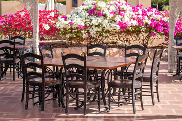 Fototapeta na wymiar Wooden table and chairs in beach cafe next to the red sea in Sharm el Sheikh, Egypt
