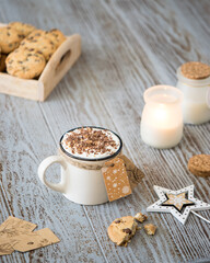 a cup of hot coffee sprinkled with chocolate with cookies