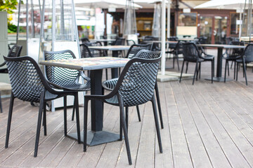 Empty chairs in outdoor cafe or restaurant on summer day