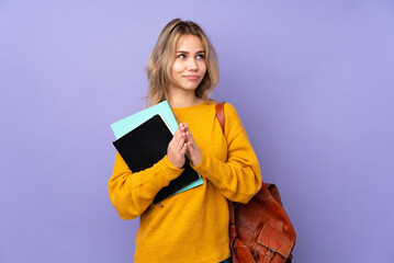Teenager Russian student girl isolated on purple background scheming something