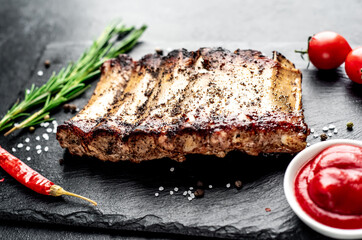 grilled pork ribs on a stone background
