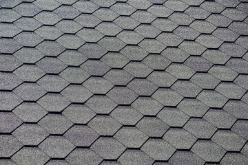 Black bitumen shingles on the roof. close-up