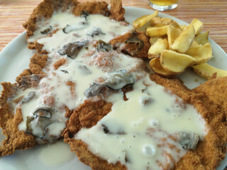 Milanese cutlet pork loin steak breaded and stuffed with cheese and truffle