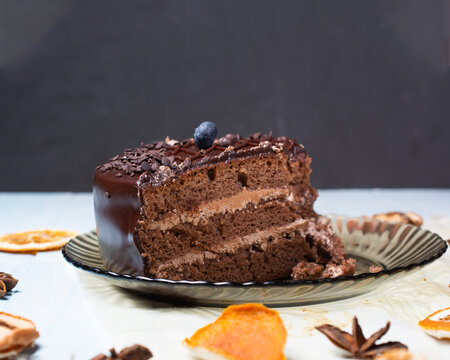 selective focus. slice of chocolate cake with blueberries on top on gray background. copy space.