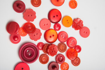 old plastic buttons in different colors on the background.