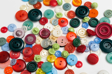 old plastic buttons in different colors on the background.