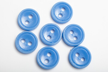 old plastic buttons in different colors on the background.