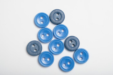 old plastic buttons in different colors on the background.