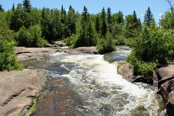 Pinawa Dam: Panoramic view of the river, stone bank and forest