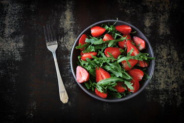 Healthy summer salad with strawberries and arugula. Summer diet.